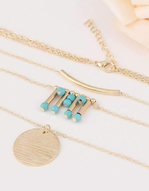 Load image into Gallery viewer, Gold Layered Necklace with Turquoise Bead Accents and Round Pendant
